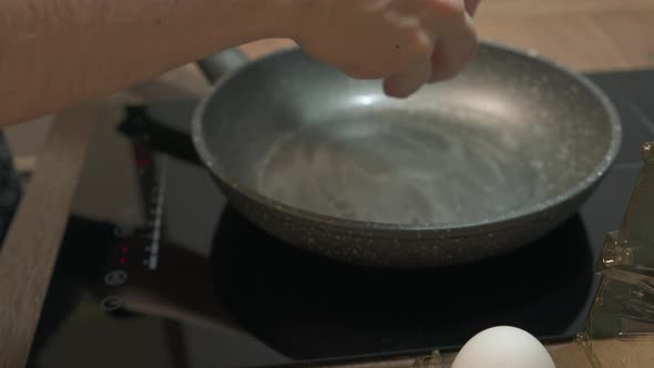 Fresh Eggs Break in Hot Frying Pan on Stove