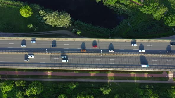 Aerial top down view of traffic jam on a car bridge anding train. 4K video alt