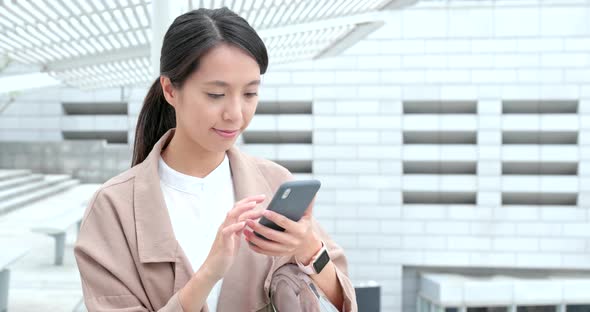 Business woman use of mobile phone alt