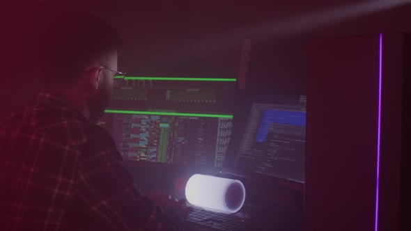 A Caucasian Man in Glasses Works on the Computer Inputs Code Types Very Fast on the Keyboard Checks alt