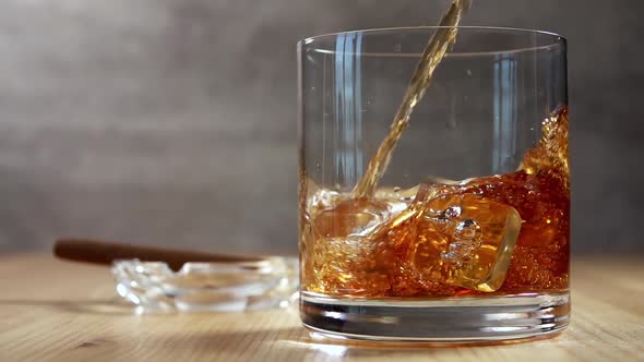 Pouring Whiskey into a Glass With Ice