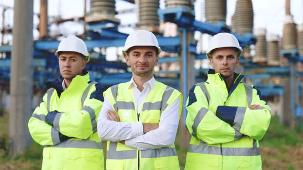 Portrait of Group of Professional Electric Industry Engineers Crossing Arms and Looks at the Camera