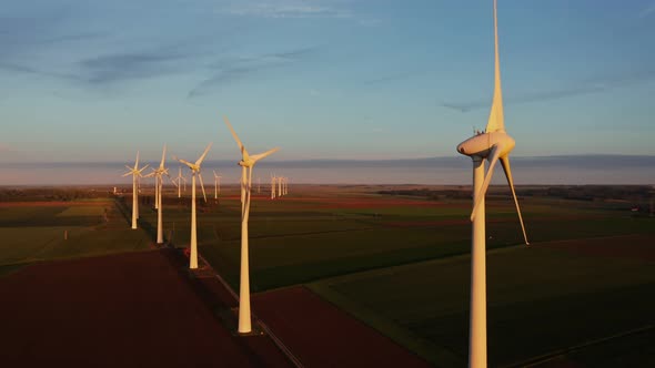 Horizontal Panning From a Drone View of a Wind Farm Among Fields alt