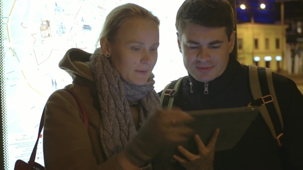 Tourists Walking In Tallinn With Tablet alt