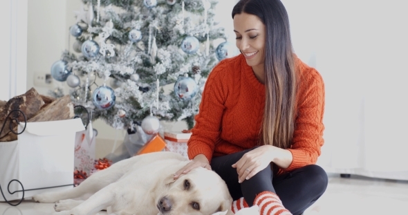 Laughing Young Woman With Her Dog At Christmas alt