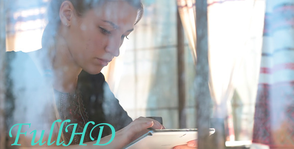 Beautiful Girl in Cafe With a Tablet