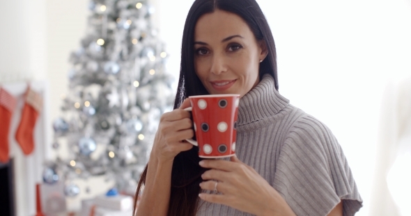 Woman Enjoying a Cup Of Christmas Coffee alt