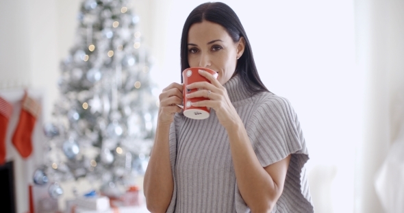 Woman Enjoying a Cup Of Christmas Coffee alt