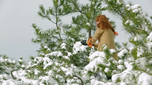 Young Cheerful Woman Throwing Snow In Winter