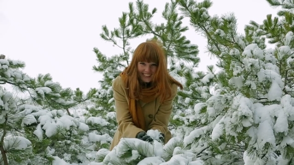 Happy Girl Playing With Snow In Forest