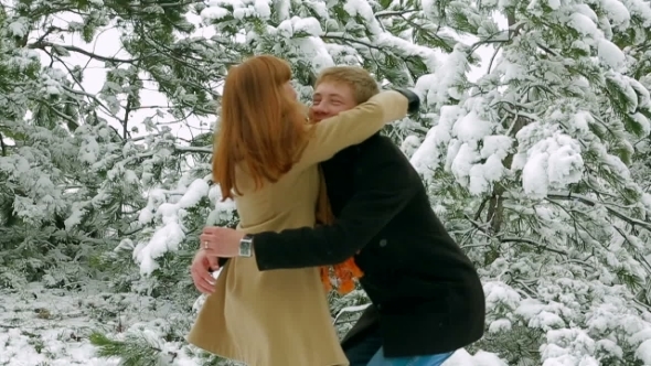 Happy Young Couple Dating In Snowy Park