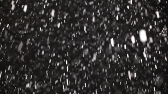 Many Fluffy Snowflakes Falling From Night Sky