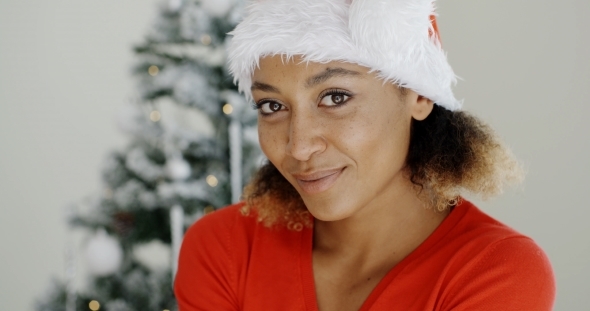Smiling Woman In a Festive Red Santa Hat alt