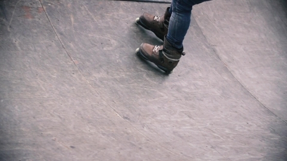 Teen With Roller Skates Performing a Stunt 