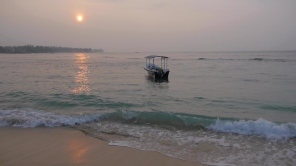 Calm Sea With a Alone Sway Boat At Sunrise