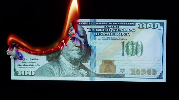 Burning American Hundred Dollar Banknote on Black Background alt