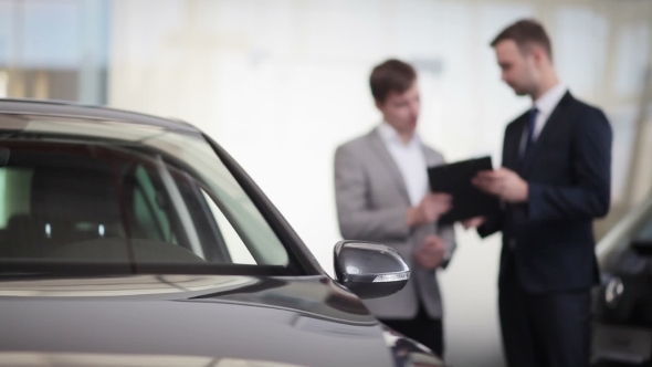 Sales Manager Assisting Client In a Car Dealership, Stock Footage ...