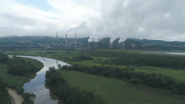 Aerial Drone View of Smoking Pipes and Cooling Towers of Coal Thermal Power Plant alt