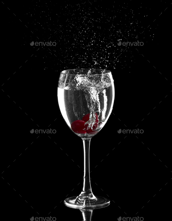 splash, with red cherries splashing in to a glass