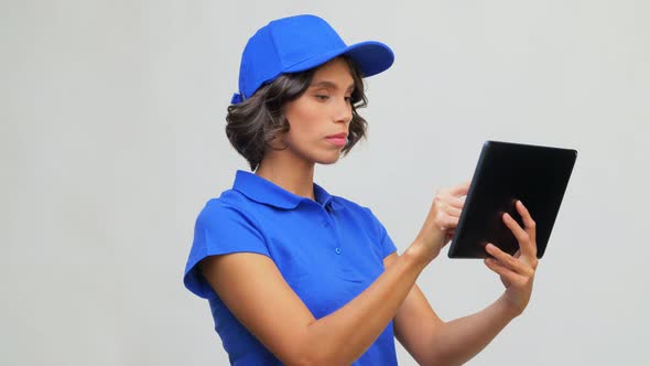 Delivery Girl in Blue Uniform with Tablet Computer alt