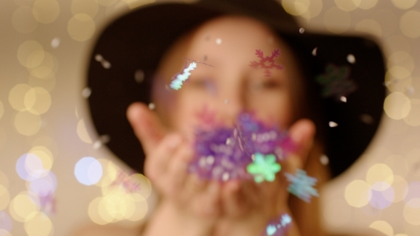 Blowing Artificial Snowflakes From Hands alt