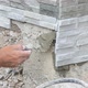 Worker Install Stone Wall Surface With Cement For House 9