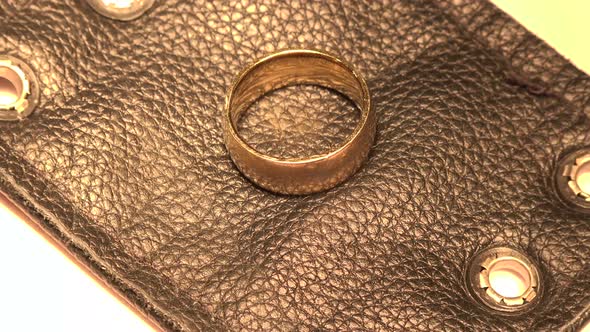 Gold Ring On Black Leather