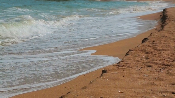 Foamy Waves Gently Washing Sandy Shore