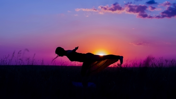 Silhouette Of a Young Girl Practicing Yoga Asanas