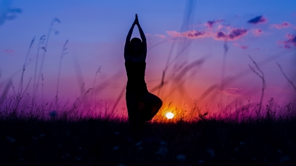 Silhouette Of a Young Girl Doing Yoga Tree Pose At