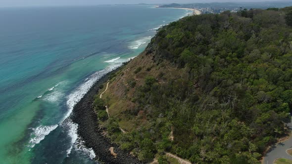 Flying backwards Burleigh Heads National Park,  waves breaking bright sunny day, walking track below alt