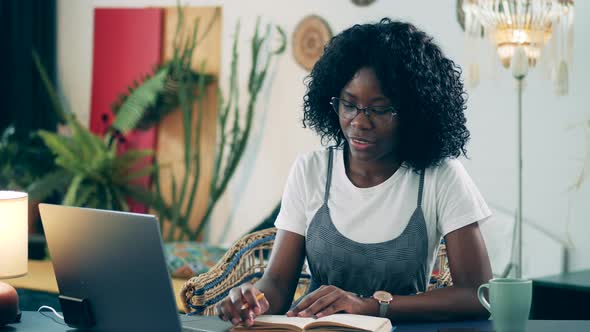 Young Woman Talks Via Laptop While Self-isolating at Home. alt
