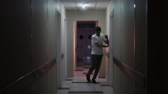 Man with a Lack of Coordination of Movement Walks Along Corridors of Hospital