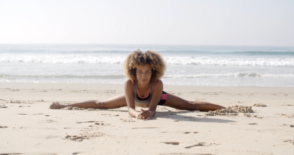 Woman In Yoga Position At The Beach alt