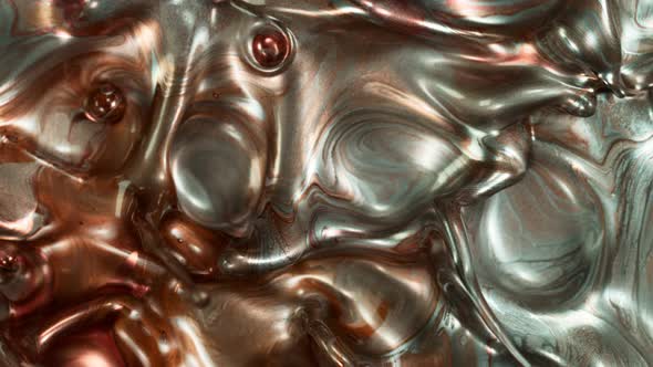 Super Slow Motion Shot of Silver and Bronze Splashing Background at 1000Fps. alt