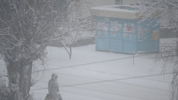 Heavy Snow Falling In City On Background Of Kiosk