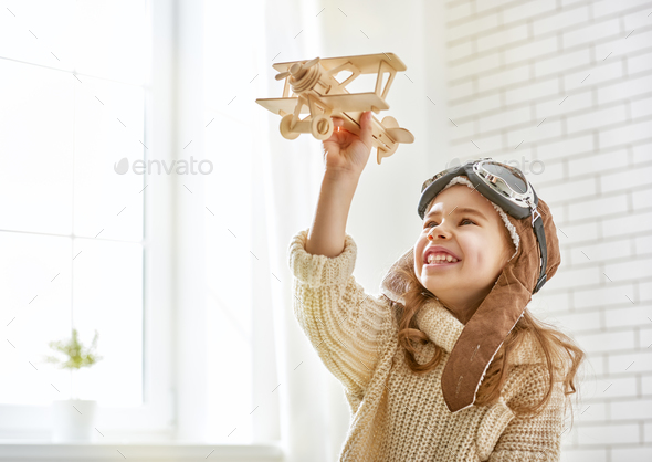 girl playing with toy airplane - Stock Photo - Images