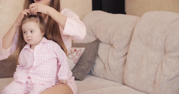 Young Beautiful Woman Holding Little Child on Her Knees