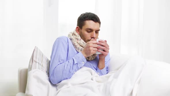 Ill Man With Flu Drinking Hot Tea At Home 2 alt