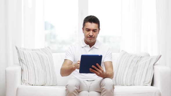 Smiling Man Working With Tablet Pc At Home 4 alt
