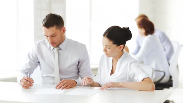 Man And Woman Signing A Contract alt