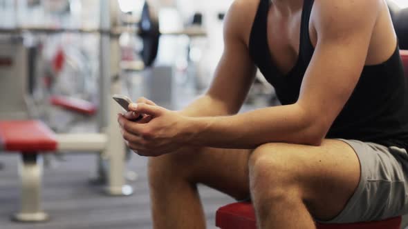 Young Man With Smartphone Computer In Gym 1 alt