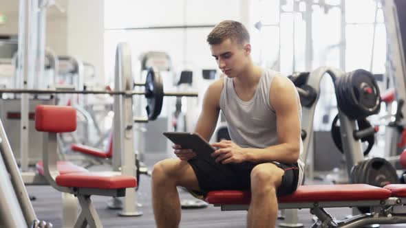 Young Man With Tablet Pc Computer In Gym 4 alt