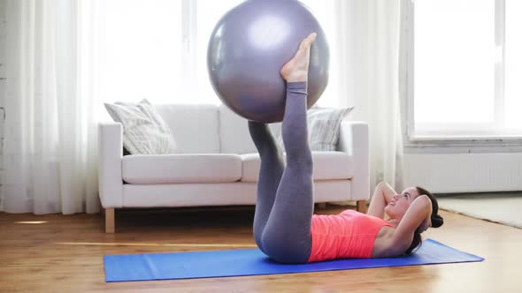 Girl Exercising With Fitness Ball At Home 2 alt