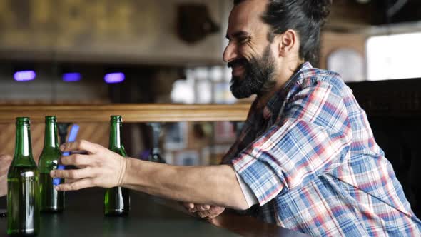 Man With Smartphone Drinking Beer At Bar Or Pub 2 alt