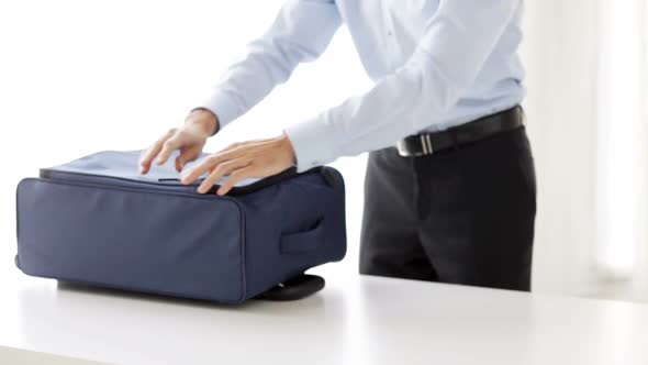 Businessman Packing Clothes Into Travel Bag 6 alt