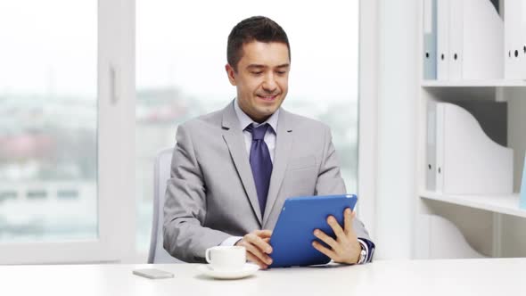 Smiling Businessman With Tablet Pc Drinking Coffee 1 alt