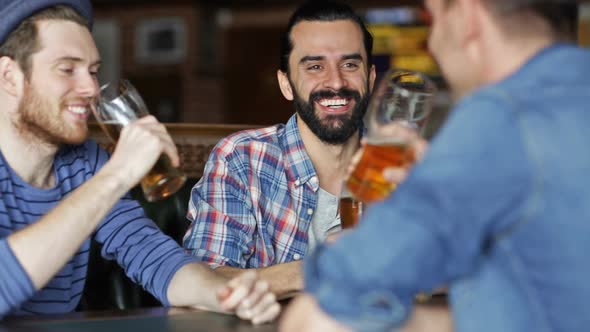 Happy Male Friends Drinking Beer At Bar Or Pub 1 alt