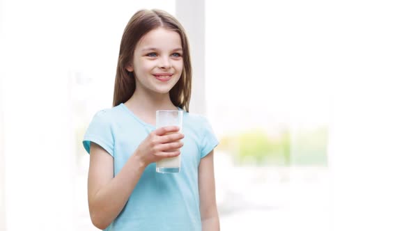 Happy Smiling Little Girl Drinking Milk At Home 2 alt