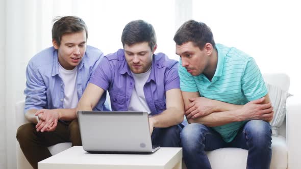 Smiling Friends With Laptop Computer At Home 2 alt